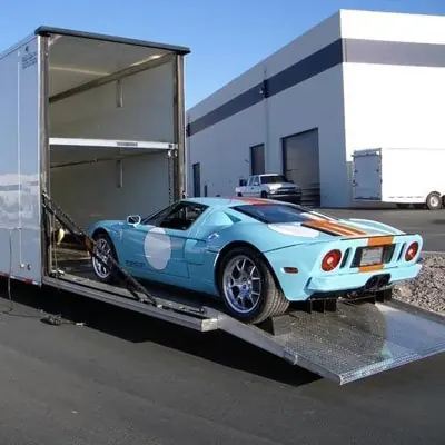 Sports car being loaded into an enclosed auto transport trailer Sports car being loaded into an enclosed auto transport trailer